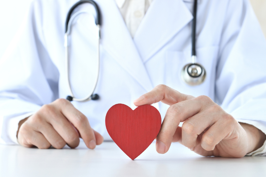 Doctor with heart shape representing care and compassion on the table