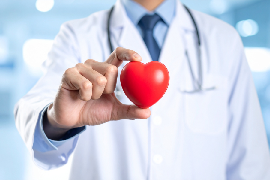 Doctor holding a heart shape symbolizing care and compassion